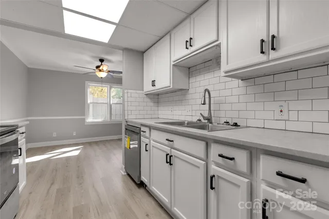 a kitchen with a sink cabinets and window