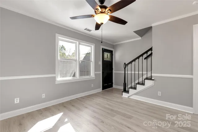 a view of entryway and hall with wooden floor