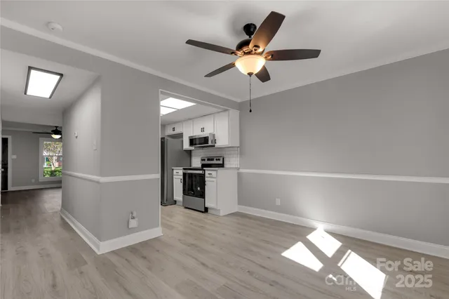 a view of kitchen with sink and wooden floor