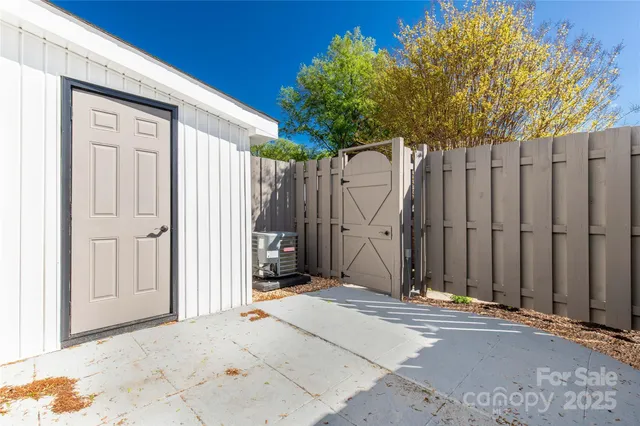 a view of a house with wooden fence