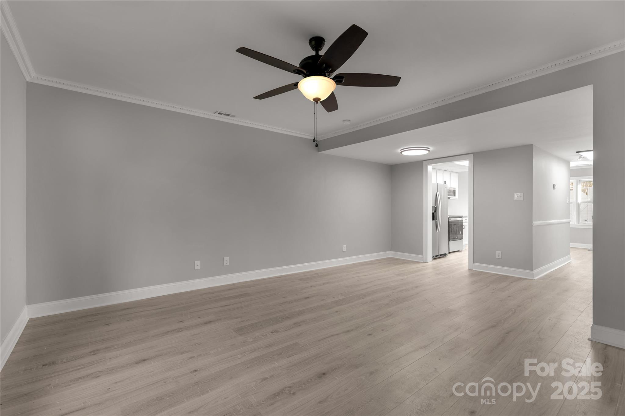 1830 Ebenezer Road Rock Hill, SC 29732 - Photo 7 of 23 a view of an empty room with wooden floor and a ceiling fan