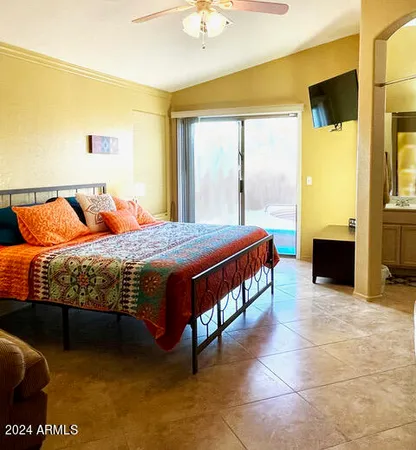a living room with a bed furniture and a chandelier