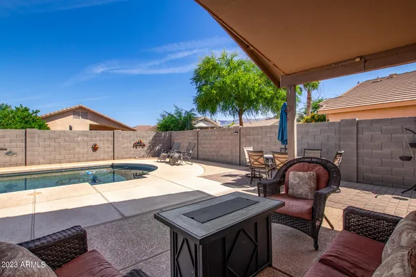 a view of a swimming pool with an outdoor seating