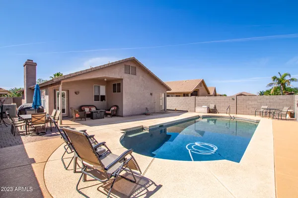 a view of a swimming pool and a lounge chair