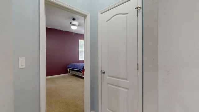 a bedroom with a bed and a lamp