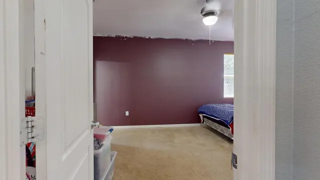 a room with a bed and wooden floor