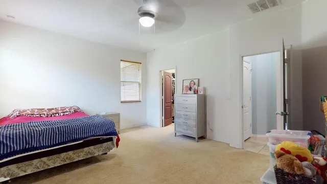 a bedroom with a bed and a window