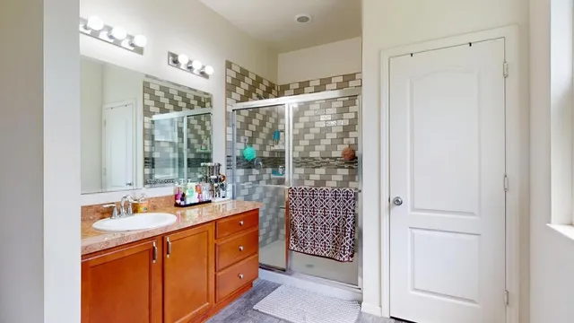 a bathroom with a sink double vanity and a shower