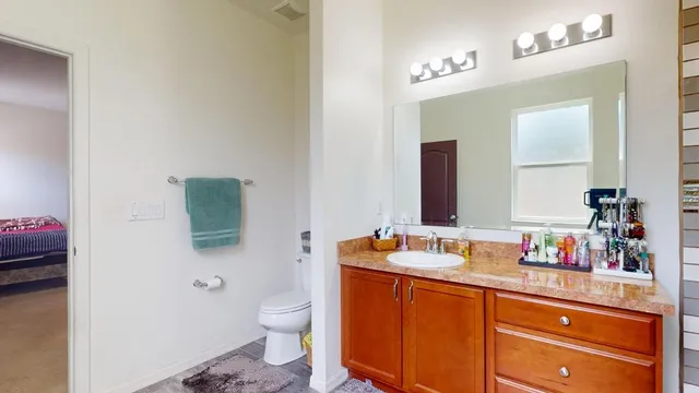 a bathroom with a sink vanity and a mirror