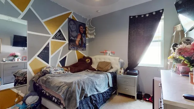 a bed room with a bed and a chair