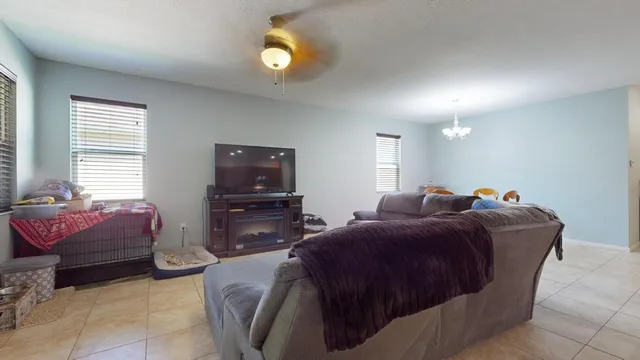 a living room with a bed furniture and a window