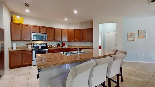 a kitchen with granite countertop a stove and cabinets