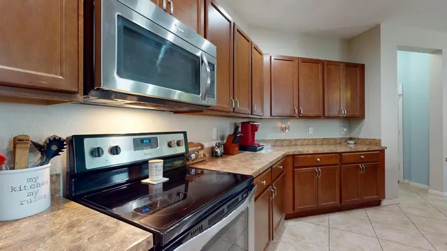 a kitchen with stainless steel appliances granite countertop a sink stove and cabinets