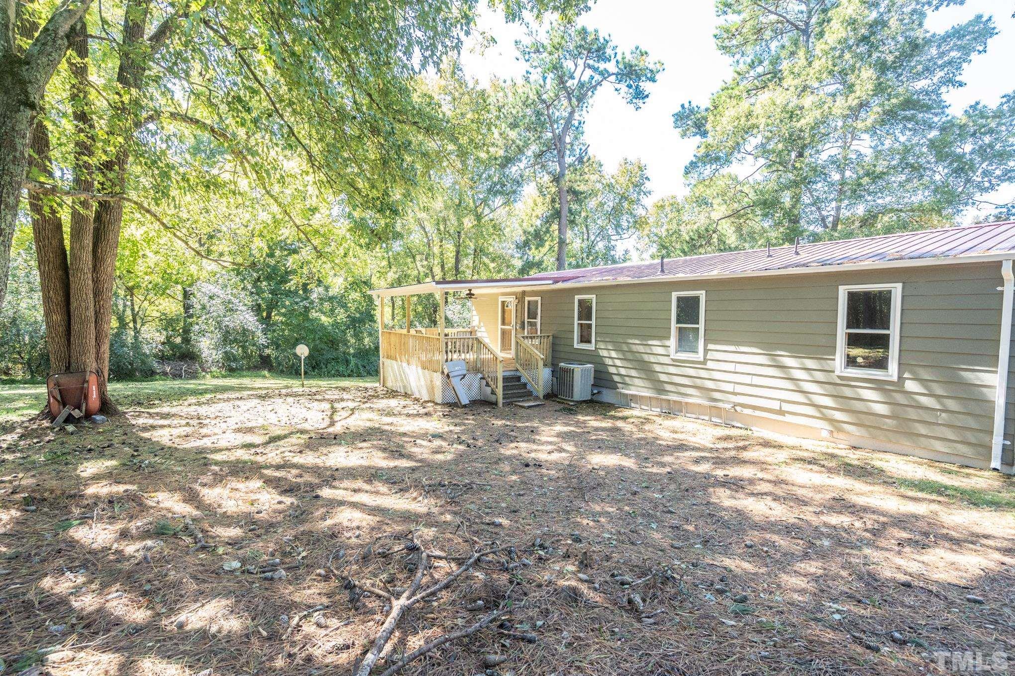 109 Old Watkins Road Henderson, NC 27537 - Photo 3 of 12 a view of a house with a backyard