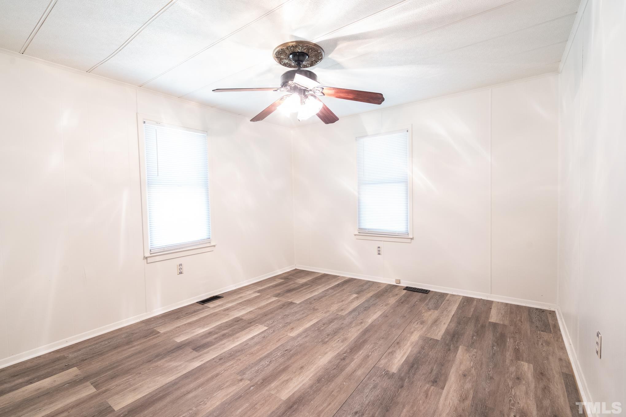 109 Old Watkins Road Henderson, NC 27537 - Photo 6 of 12 an empty room with a window and a ceiling fan