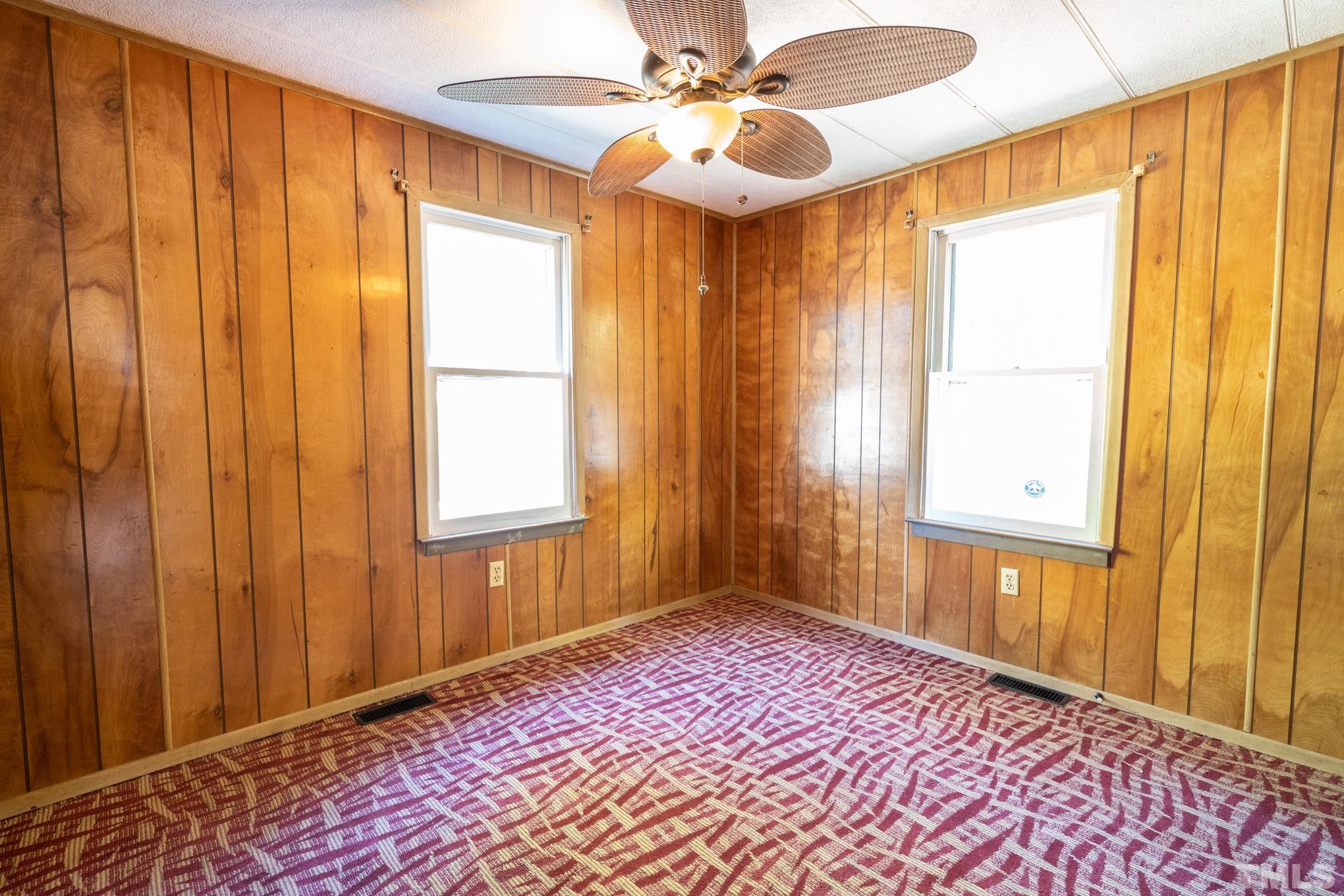 109 Old Watkins Road Henderson, NC 27537 - Photo 7 of 12 a view of a room with a window and a chandelier fan
