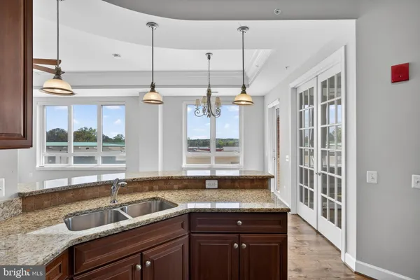 an empty room with wooden floor and ceiling fan