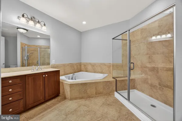 a bathroom with a granite countertop sink a toilet and a mirror