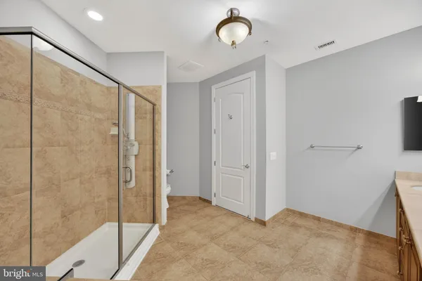 a kitchen with stainless steel appliances granite countertop a sink and a refrigerator