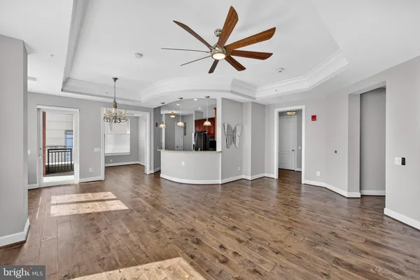 a view of a livingroom with a ceiling fan and wooden floor