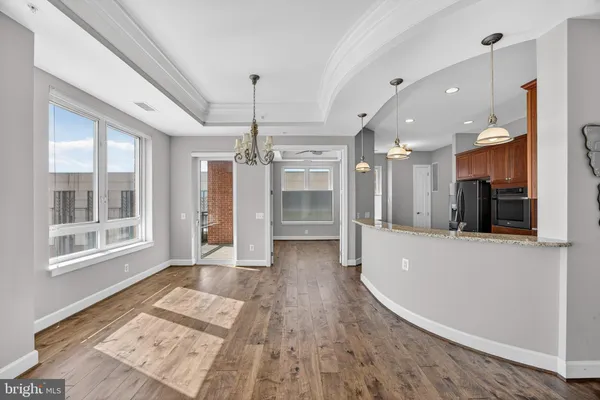 a view of a big room with wooden floor and a window