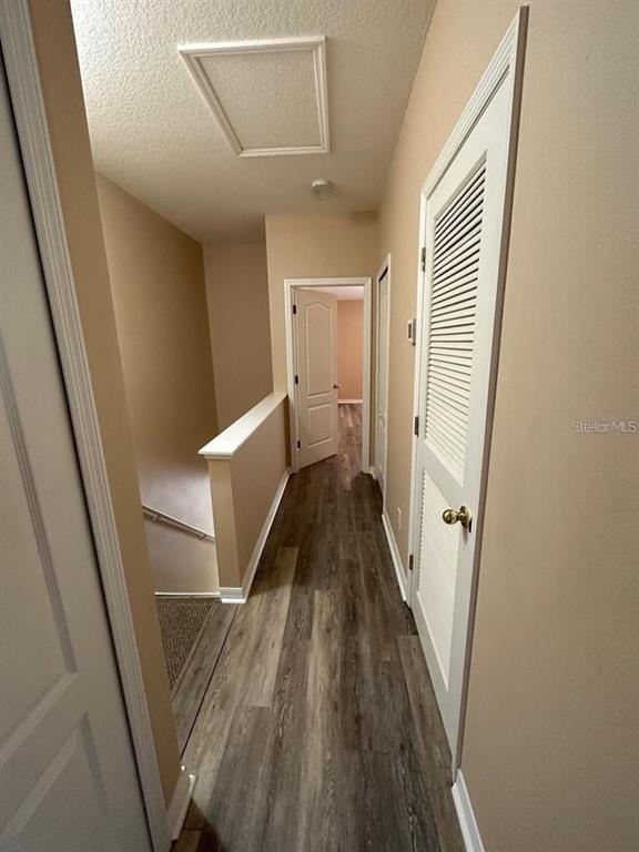 5882 Fishhawk Ridge Drive Lithia, FL 33547 - Photo 24 of 34 a view of a hallway with wooden floor and staircase