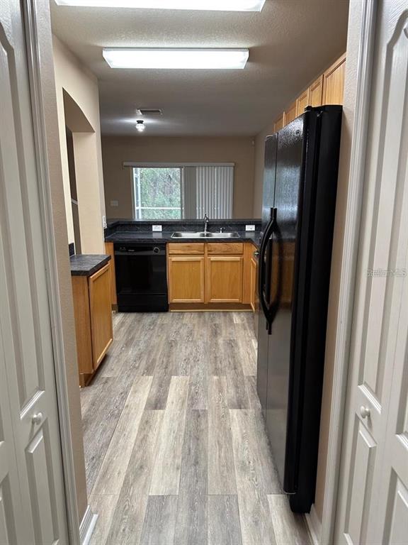 5882 Fishhawk Ridge Drive Lithia, FL 33547 - Photo 6 of 34 a kitchen with stainless steel appliances granite countertop a refrigerator and a sink