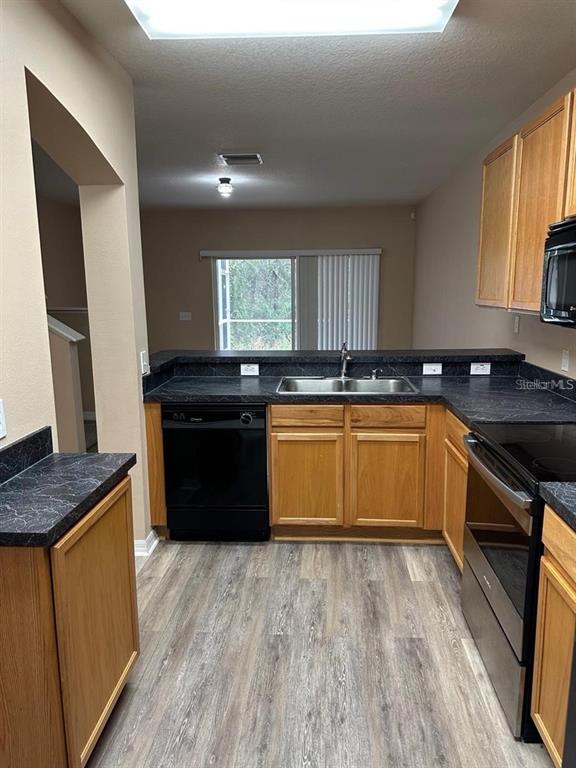 5882 Fishhawk Ridge Drive Lithia, FL 33547 - Photo 7 of 34 a kitchen with stainless steel appliances granite countertop a sink and stove