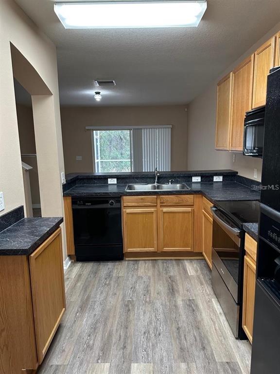 5882 Fishhawk Ridge Drive Lithia, FL 33547 - Photo 10 of 34 a kitchen with granite countertop a sink counter top space and cabinets