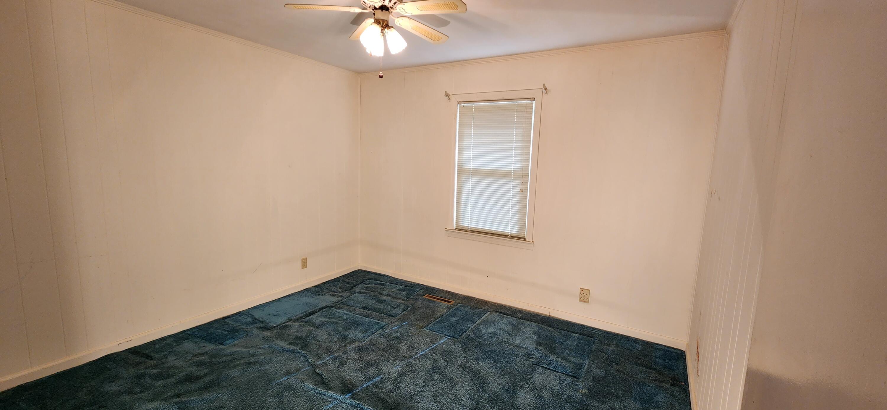 2805 Ruritan Road Rocky Mount, VA 24151 - Photo 12 of 24 an empty room with a chandelier fan