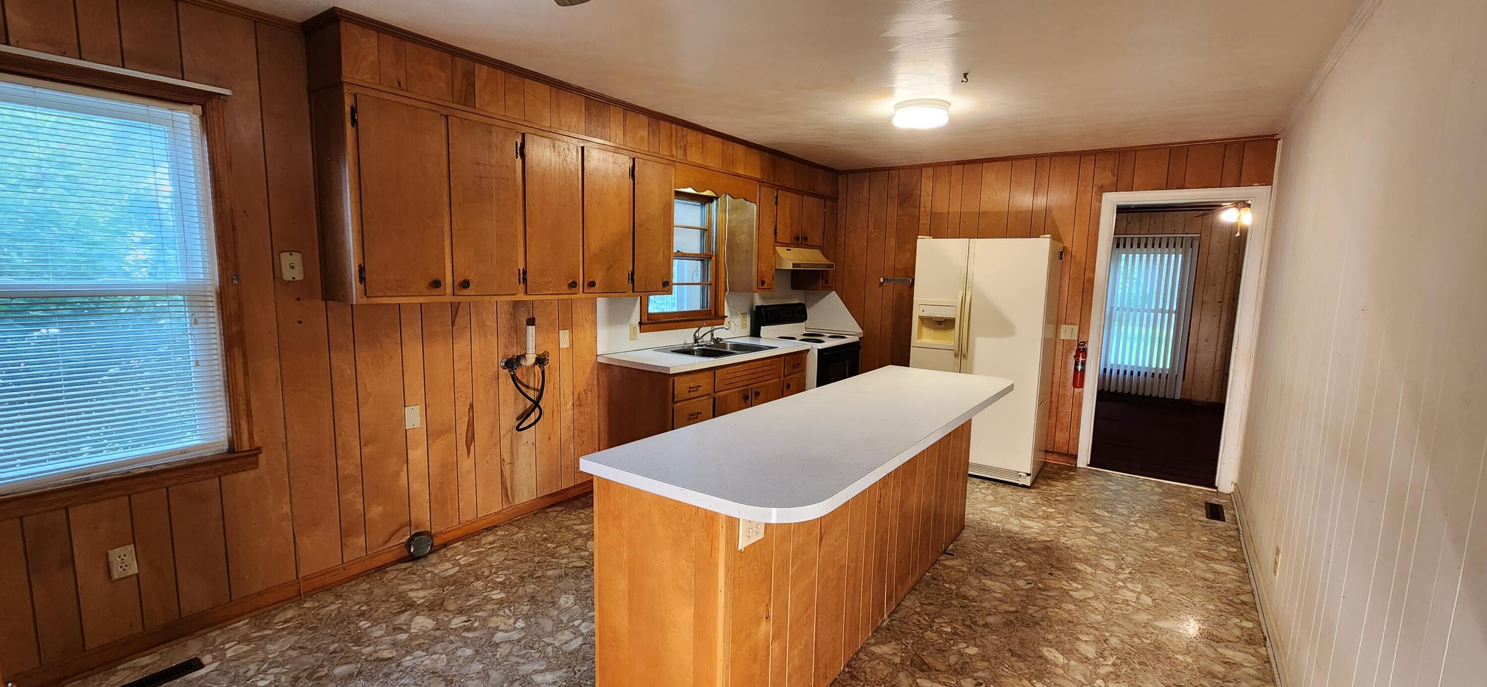 2805 Ruritan Road Rocky Mount, VA 24151 - Photo 6 of 24 a kitchen with refrigerator and cabinets