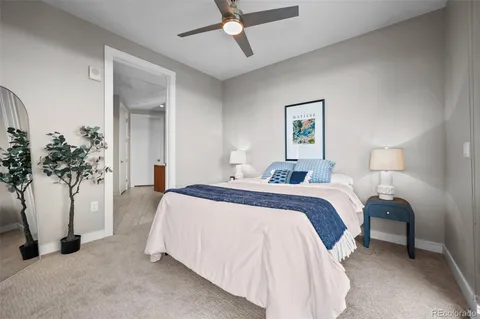 a spacious bedroom with a bed and a potted plant