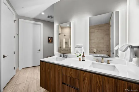 a bathroom with a double vanity sink and a mirror