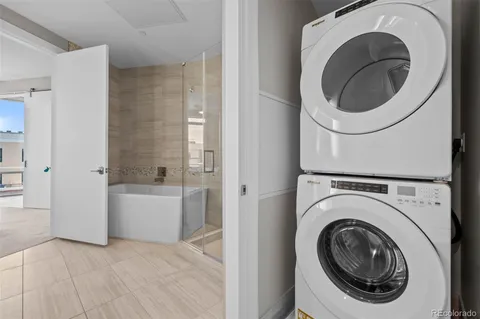 a view of a hallway with washer and dryer