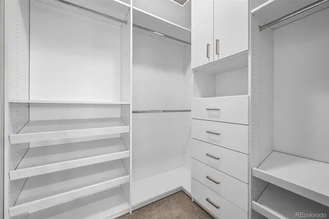 a view of walk in closet with empty racks
