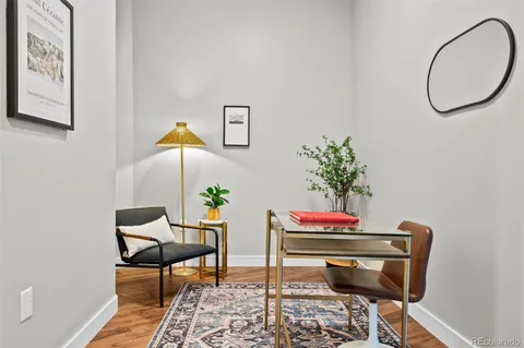 a workspace with furniture and a potted plant