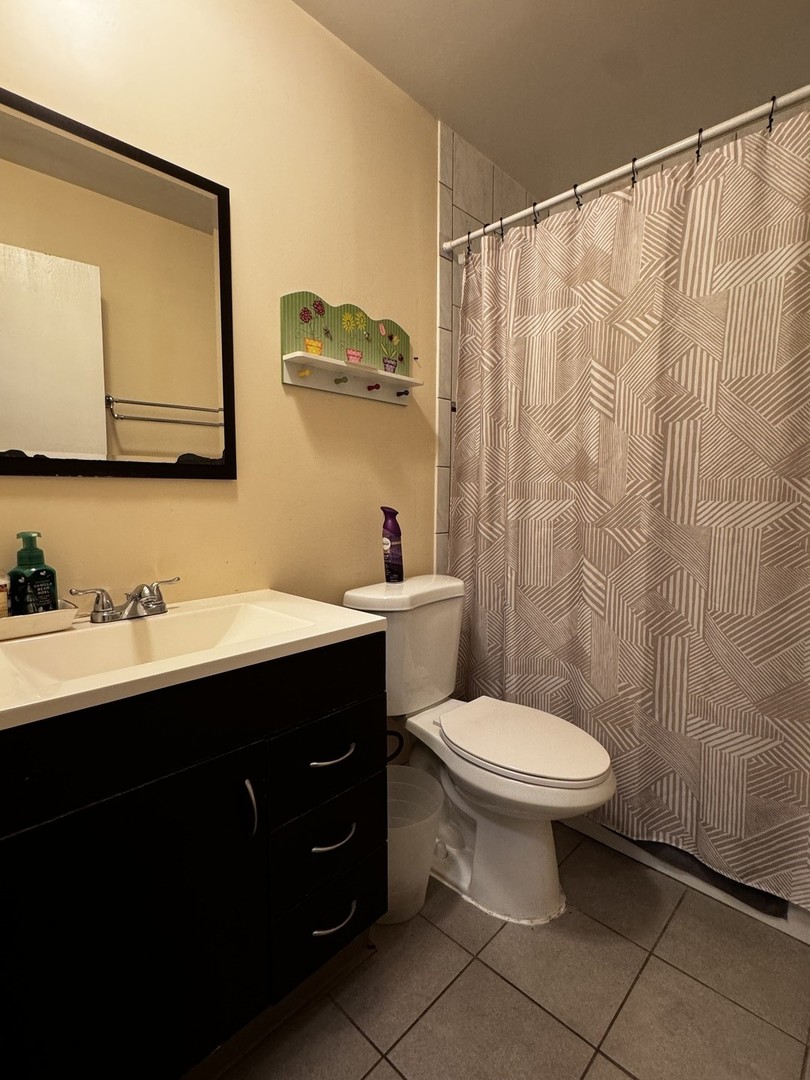 264 George Street, Unit A Bensenville, IL 60106 - Photo 5 of 7 a bathroom with a sink toilet and mirror