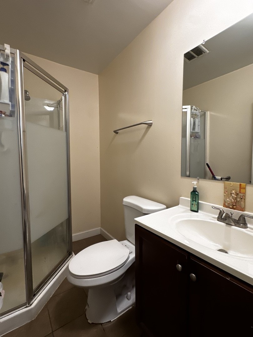 264 George Street, Unit A Bensenville, IL 60106 - Photo 6 of 7 a bathroom with a sink and a toilet