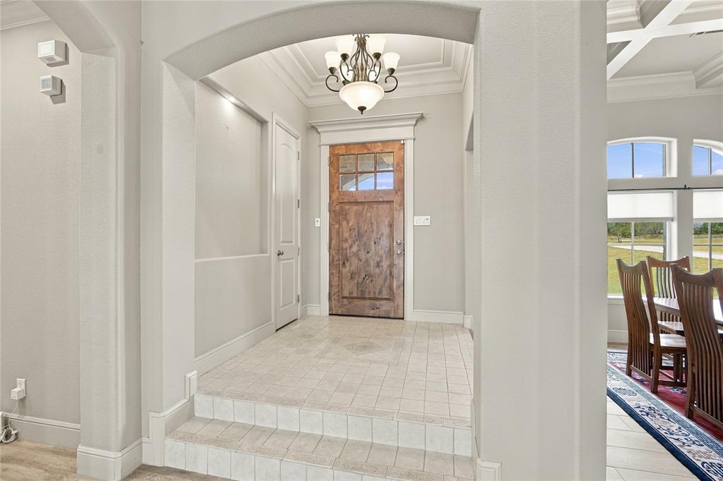1180 Wiggins Road Maypearl, TX 76064 - Photo 5 of 40 Step through the arched entry onto durable tile flooring, a warm and welcoming first impression.