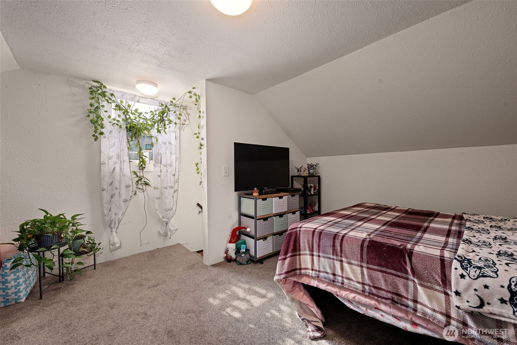 1218 Cedar Street Raymond, WA 98577 - Photo 25 of 31 a bedroom with a bed and a flat screen tv