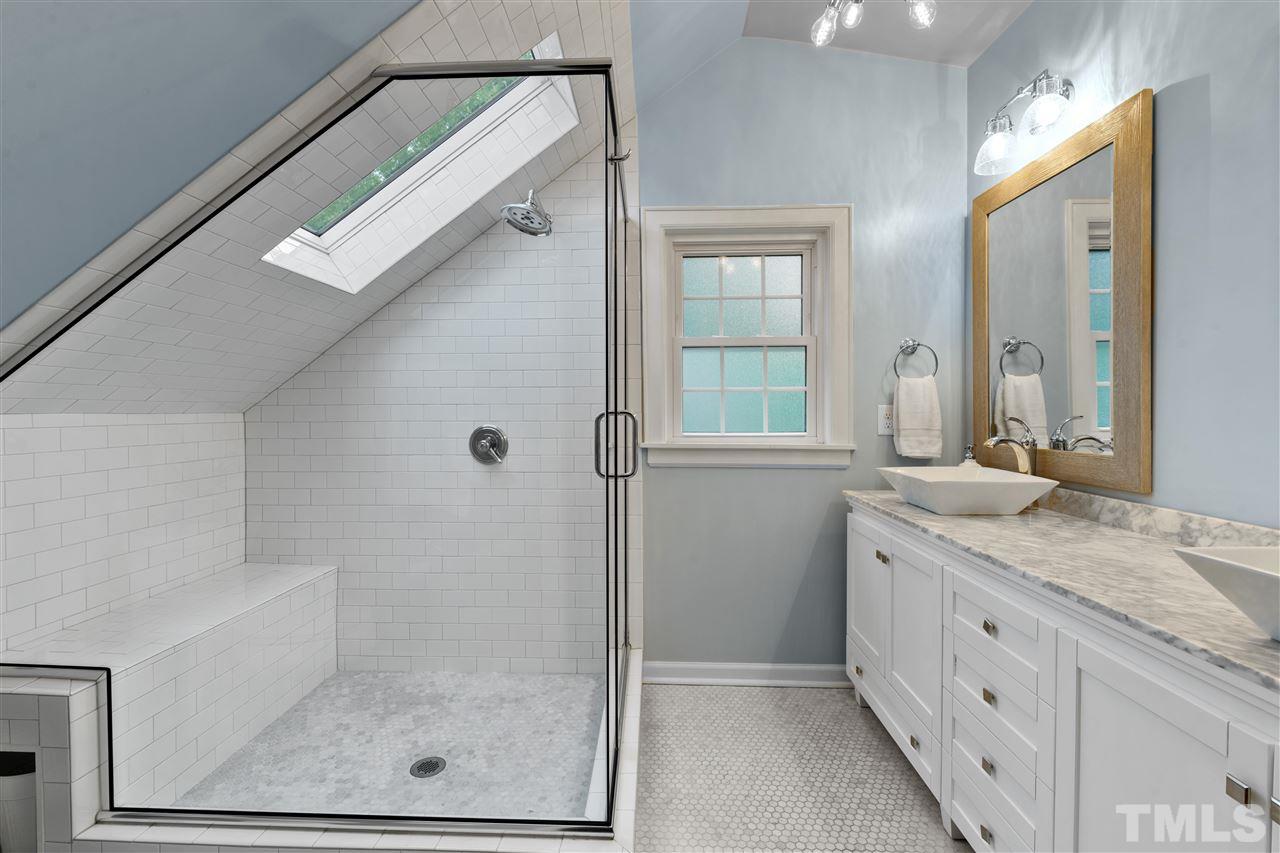 2618 Van Dyke Avenue Raleigh, NC 27607 - Photo 14 of 30 a bathroom with a granite countertop sink a mirror and a shower