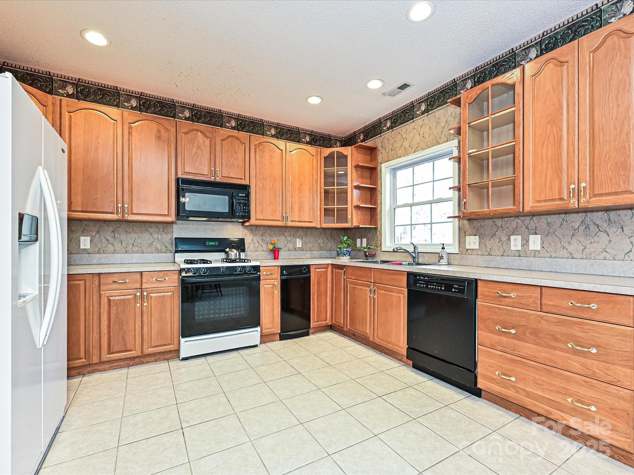 25040 Timberlake Drive Tega Cay, SC 29708 - Photo 11 of 40 a kitchen with stainless steel appliances granite countertop a refrigerator sink and stove top oven