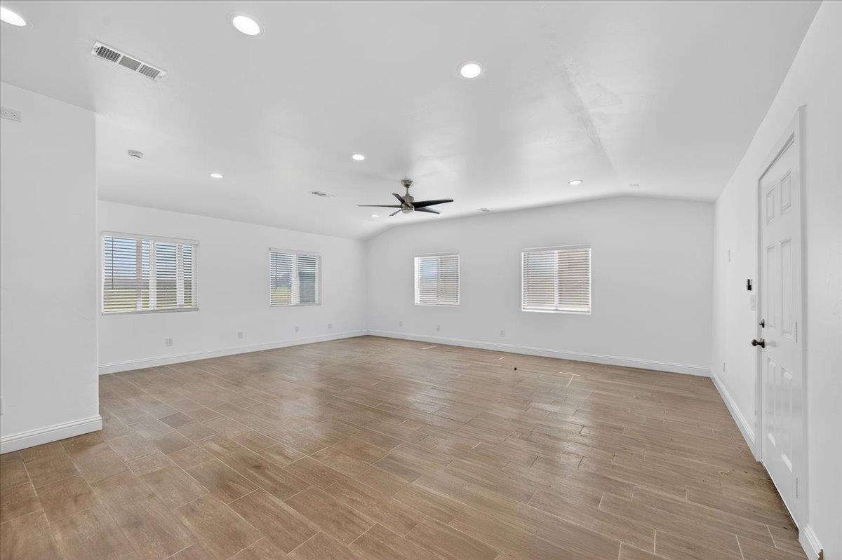 6873 20th Avenue Lemoore, CA 93245 - Photo 4 of 90 wooden floor in an empty room with a window