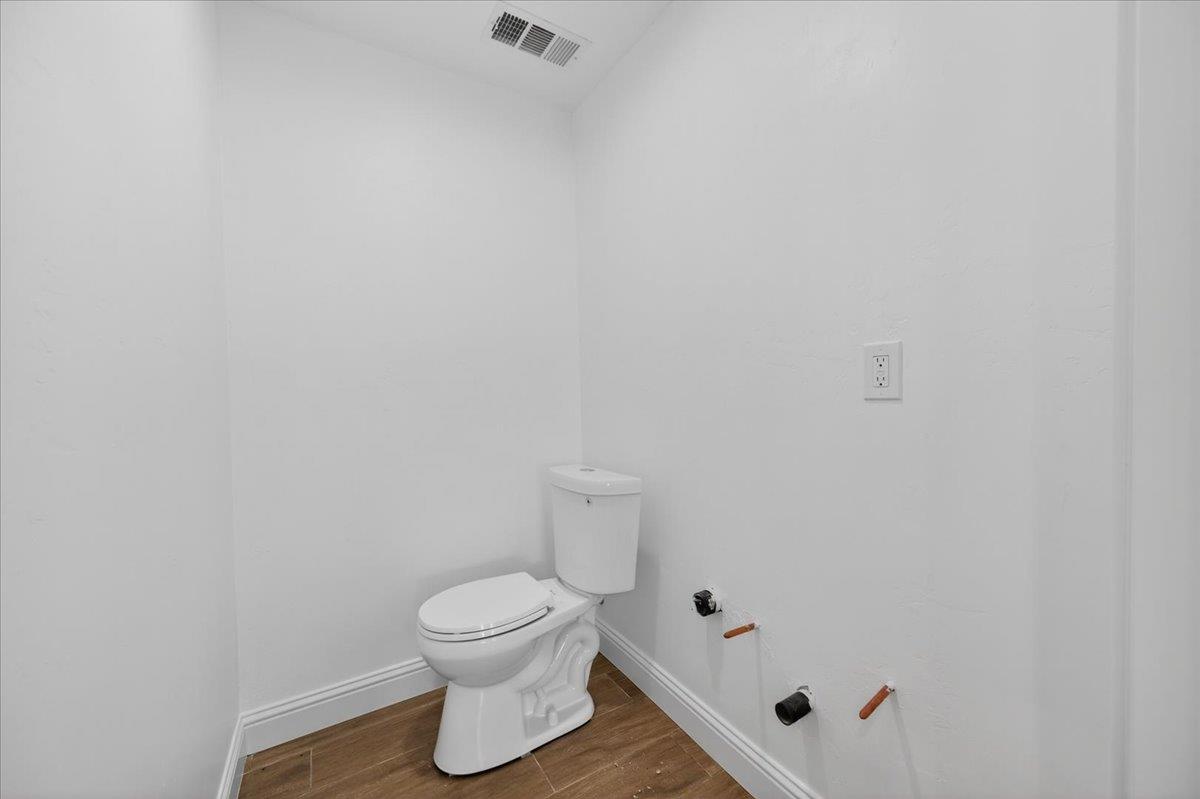 6873 20th Avenue Lemoore, CA 93245 - Photo 6 of 90 a bathroom with a toilet and a shower