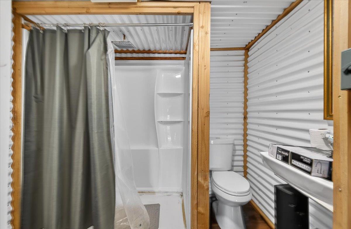 6873 20th Avenue Lemoore, CA 93245 - Photo 65 of 90 a bathroom with a toilet a sink and shower
