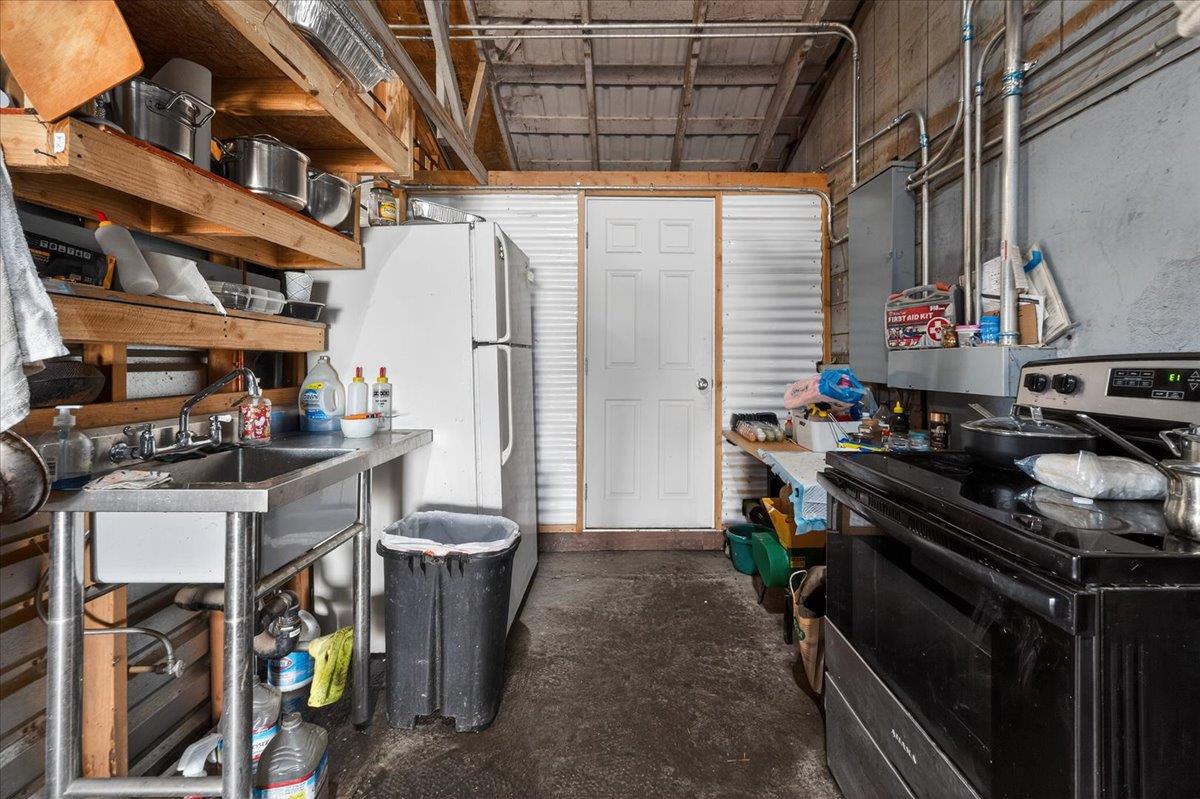 6873 20th Avenue Lemoore, CA 93245 - Photo 66 of 90 a kitchen with stainless steel appliances granite countertop a stove a sink and a refrigerator