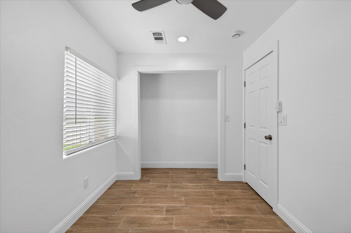 6873 20th Avenue Lemoore, CA 93245 - Photo 7 of 90 a view of an empty room with a window and closet area