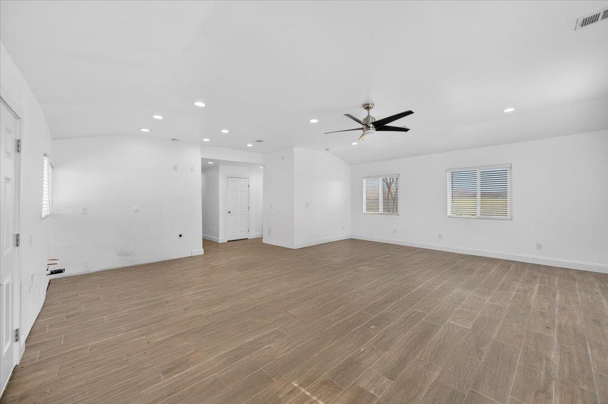 6873 20th Avenue Lemoore, CA 93245 - Photo 79 of 90 an empty room with a ceiling fan and wooden floor