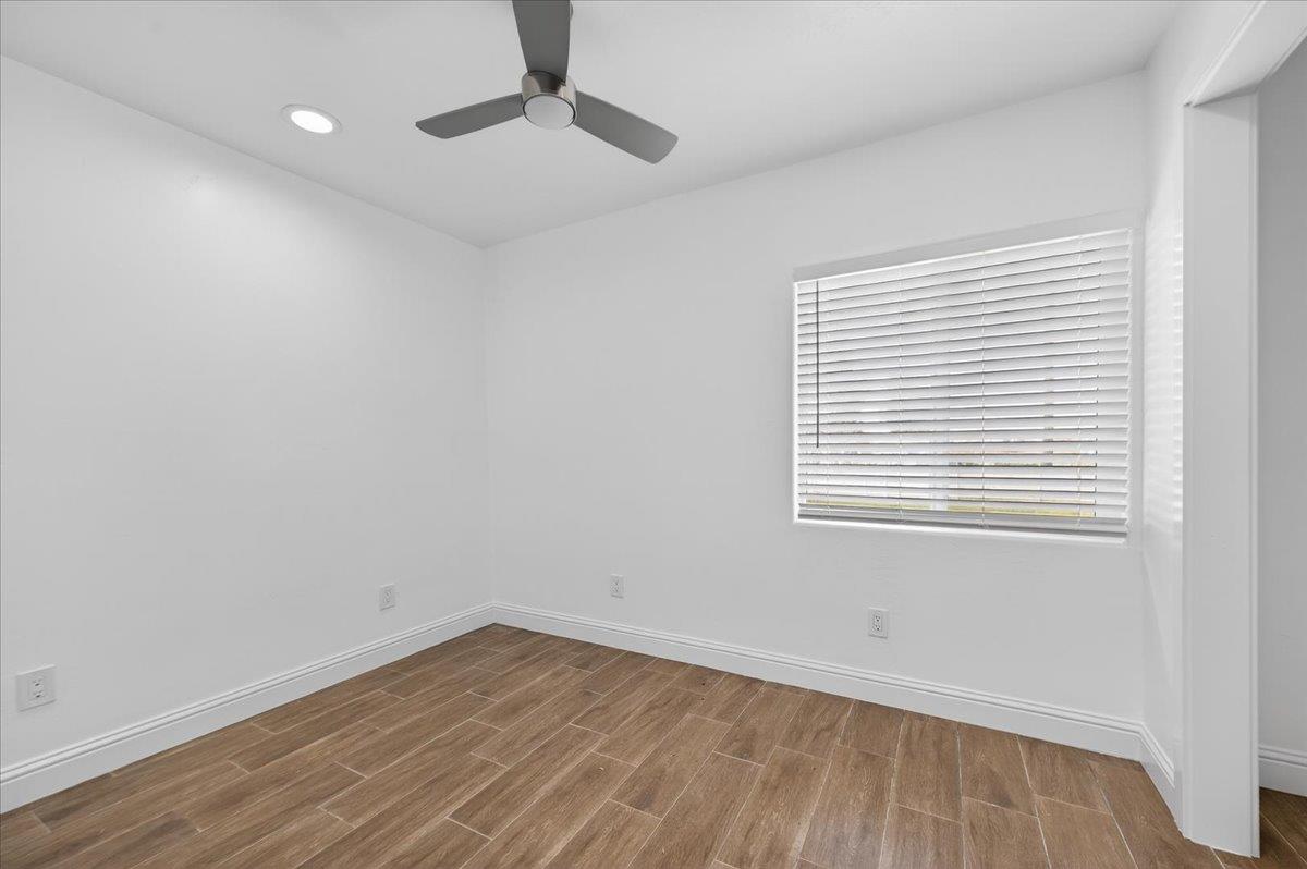 6873 20th Avenue Lemoore, CA 93245 - Photo 8 of 90 wooden floor in an empty room with a window