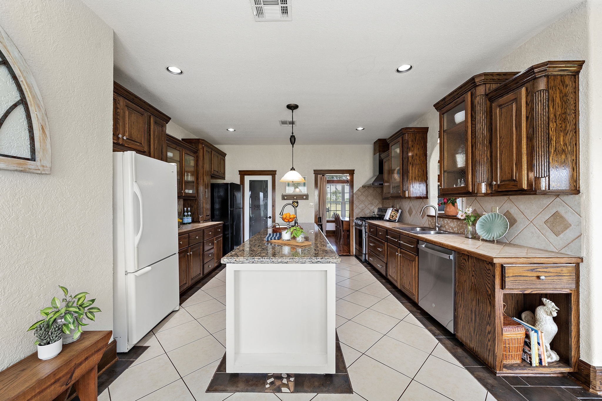 10411 County Road 65 Rosharon, TX 77583 - Photo 13 of 29 The kitchen is well equipped with two sinks, a gas range, and space for two refrigerators, making it ideal for everyday cooking and hosting with ease.